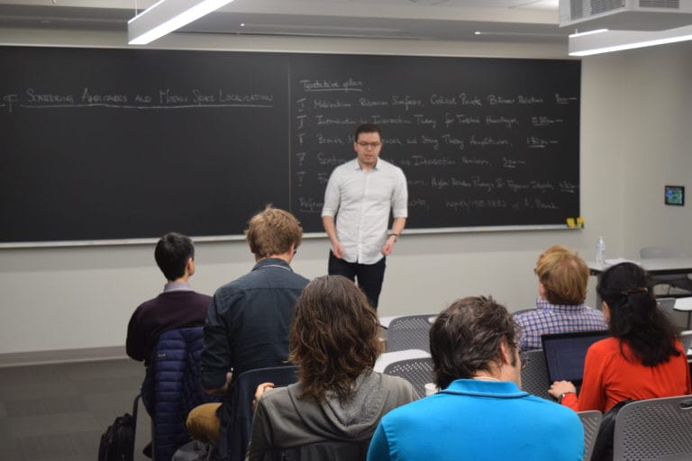 Photos from the Spacetime Masterclass Workshop -Presenter in White Shirt Delivering Speech